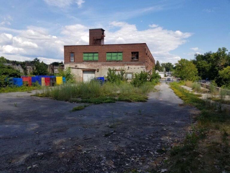 Brick industrial building and paved yard at the former tannery property at 125 Bath Street, as shown in the filed applicant presentation.